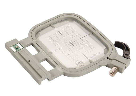 A close-up view of the manual presser foot pressure tension adjustment dial on a machine casing.