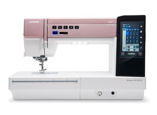 Janome Memory Craft 9410QC computerized sewing machine with a pink accent faceplate.