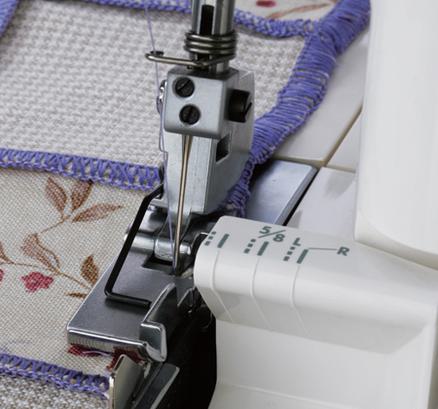 A metal Janome serger cloth guide aligned with patterned fabric on a serger machine bed.