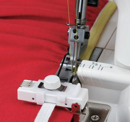 A Janome serger elastic gathering attachment stitching a yellow elastic band onto red fabric.